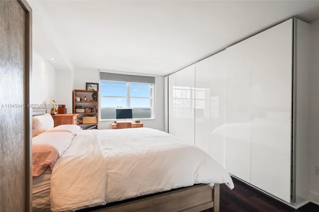 a large bed sitting in a bedroom next to a window