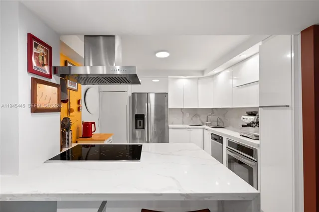 a kitchen with stainless steel appliances a sink and a refrigerator
