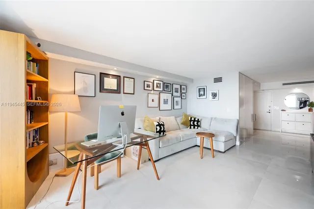 a living room with furniture and a bookshelf