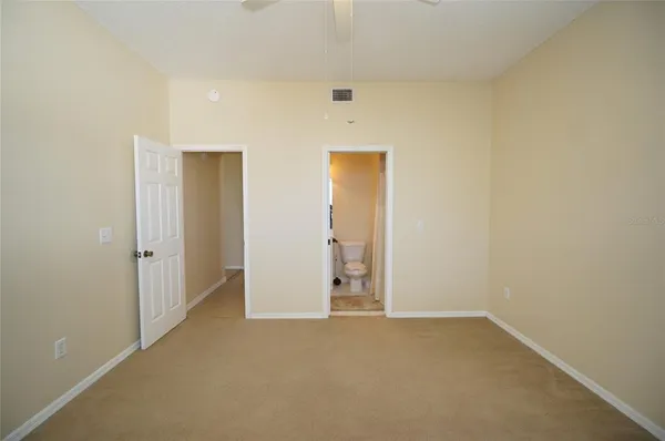 a view of a room that has a sink and a mirror