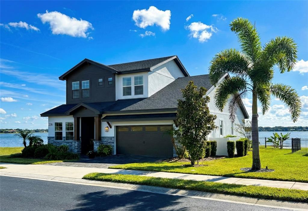 236 Caladium Avenue Lake Alfred, FL 33850 - Photo 2 of 58 a front view of a house with yard and green space