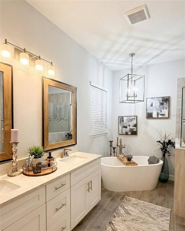 236 Caladium Avenue Lake Alfred, FL 33850 - Photo 26 of 58 a bathroom with a double vanity sink mirror and double