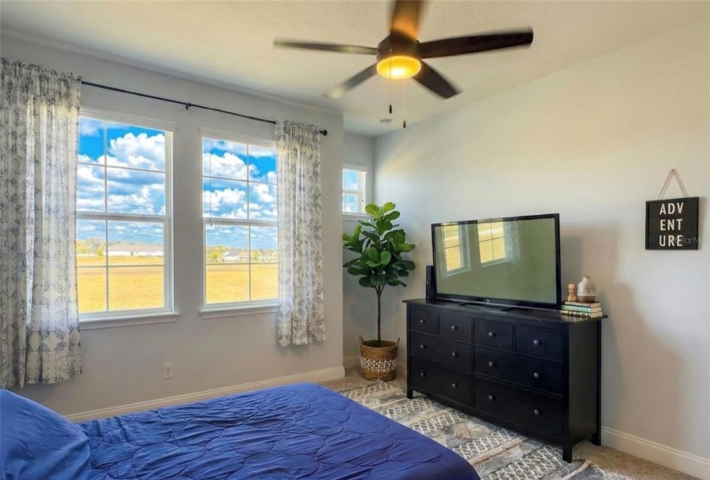 236 Caladium Avenue Lake Alfred, FL 33850 - Photo 38 of 58 a bedroom with a bed and a mirror on the dresser