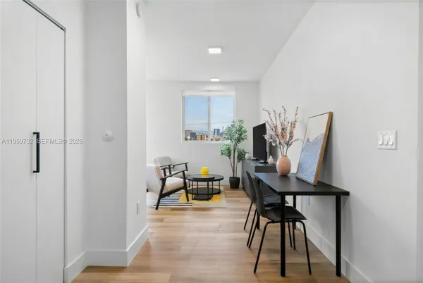 a view of a room with furniture and wooden floor