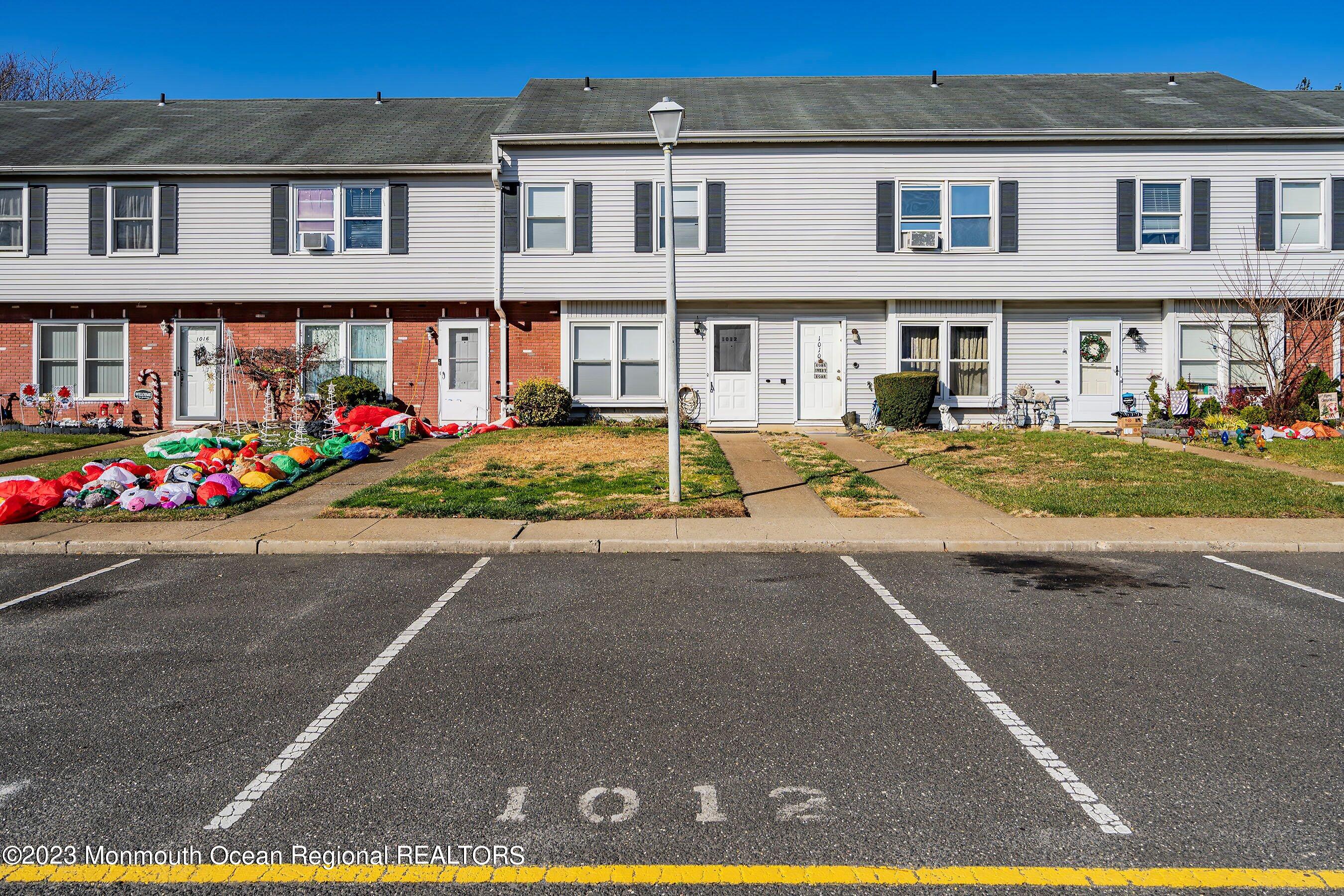 1012 Sawmill Road, Unit 6 Brick, NJ 08724 - Photo 1 of 24 a view of a white house with a swimming pool