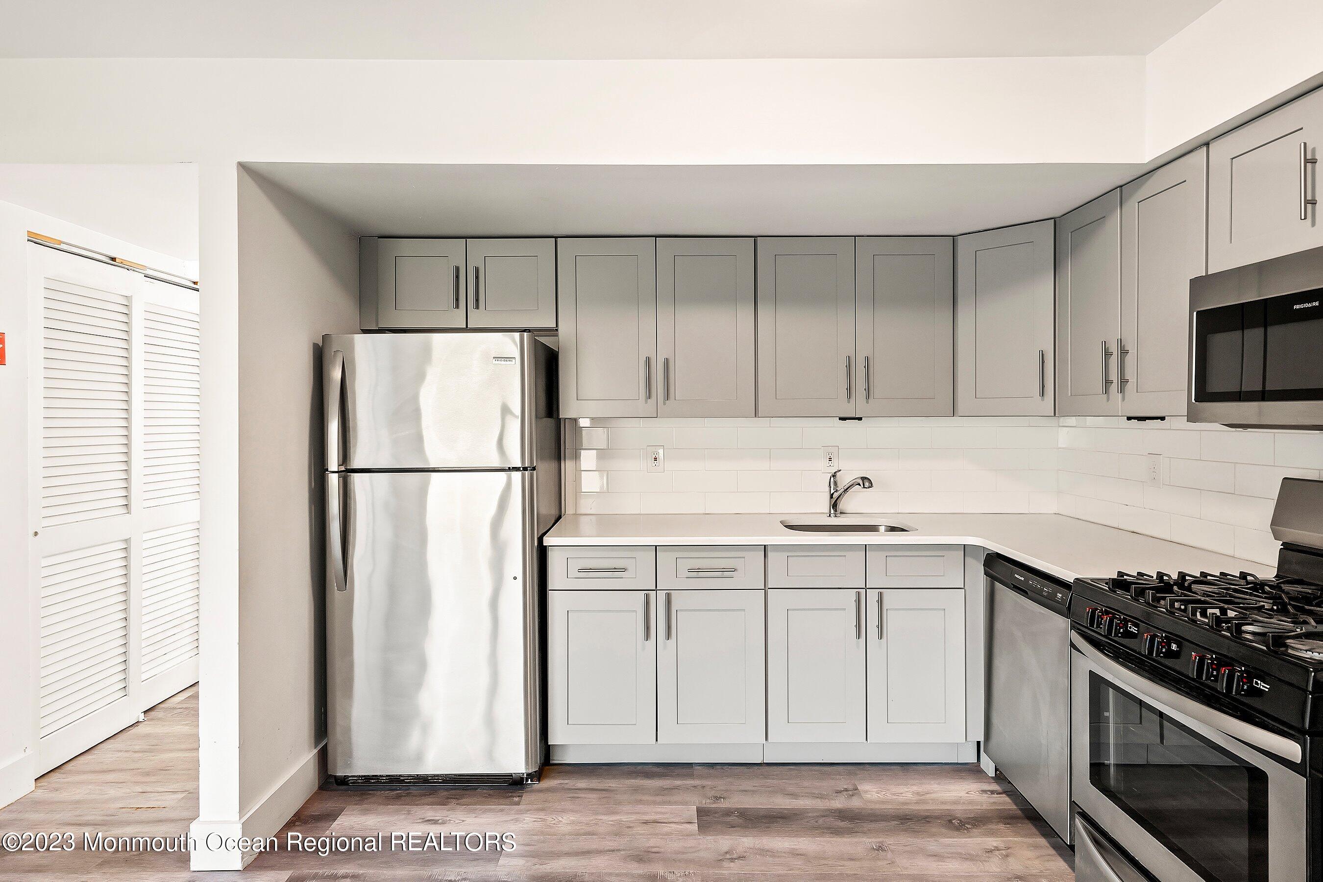 1012 Sawmill Road, Unit 6 Brick, NJ 08724 - Photo 16 of 24 a kitchen with stainless steel appliances granite countertop a refrigerator stove a sink and dishwasher