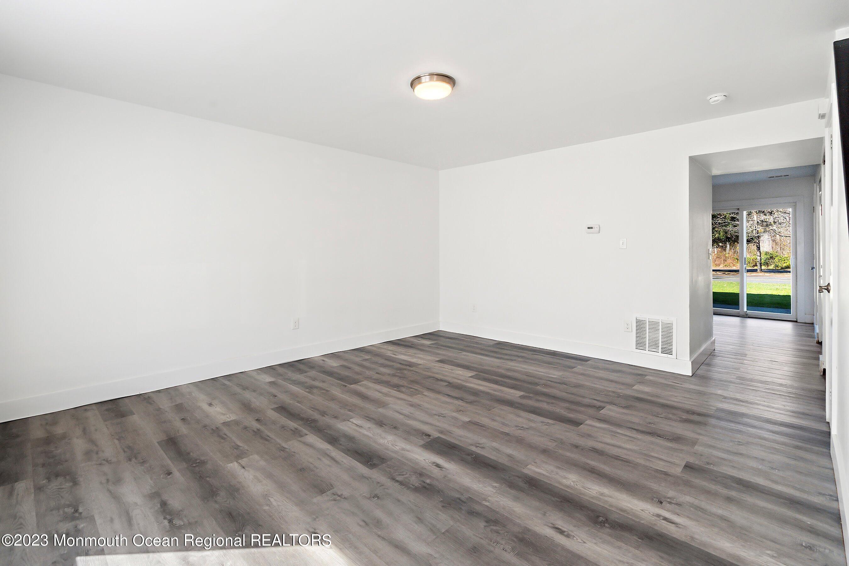 1012 Sawmill Road, Unit 6 Brick, NJ 08724 - Photo 5 of 24 a view of empty room with wooden floor and fan