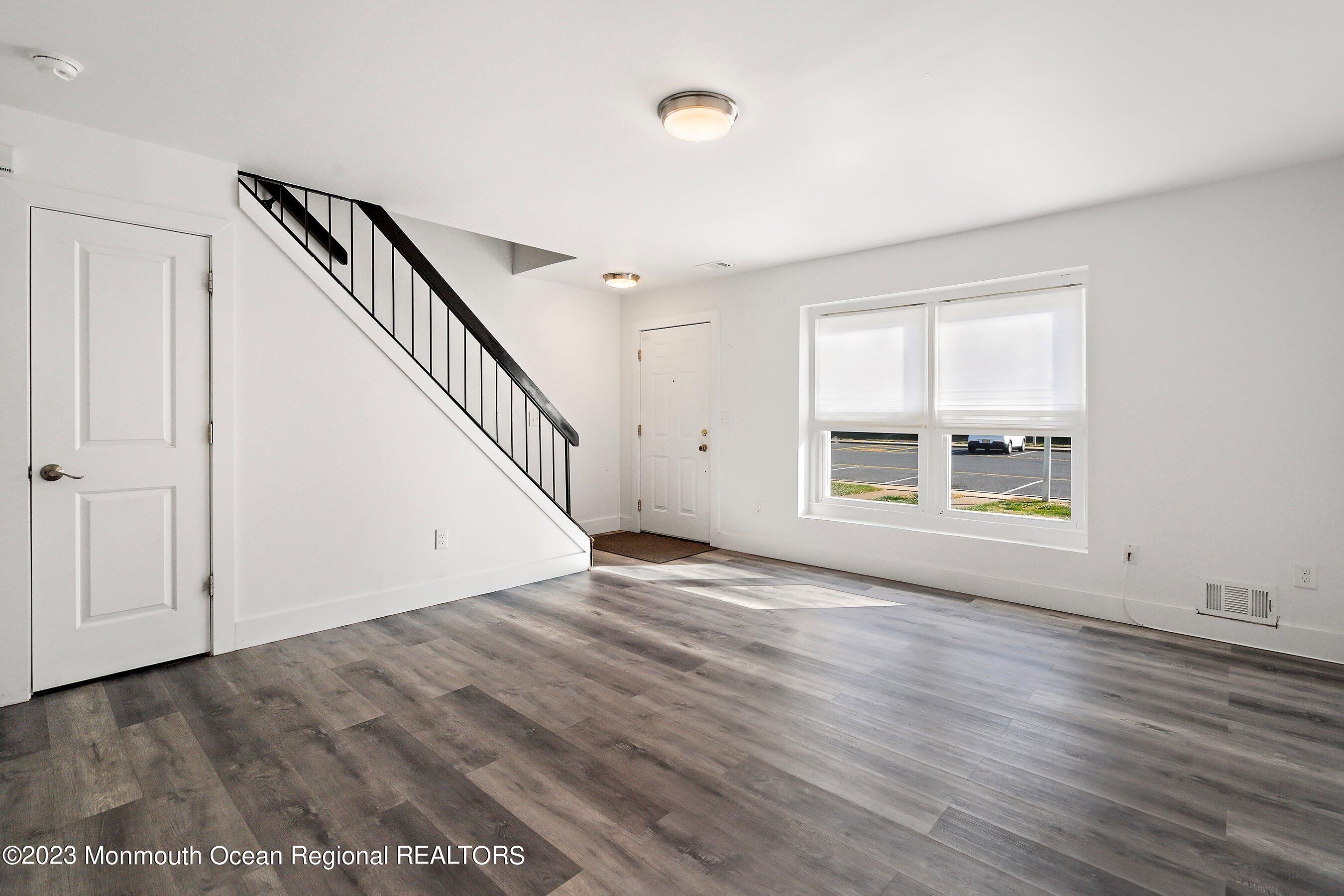 1012 Sawmill Road, Unit 6 Brick, NJ 08724 - Photo 7 of 24 a view of an empty room with wooden floor and a window