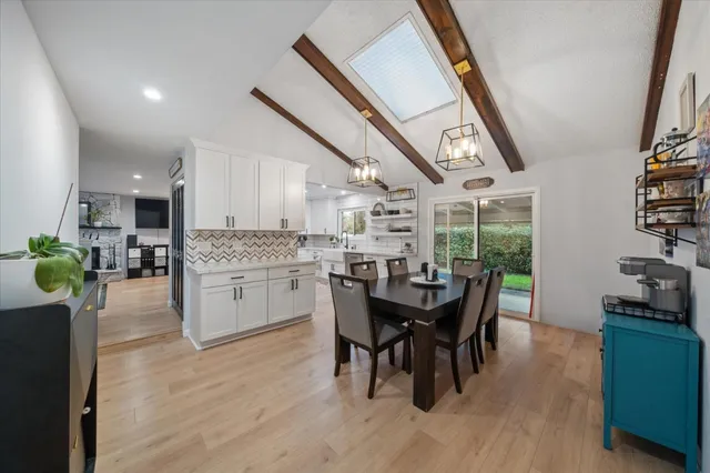 a dining room with furniture and wooden floor