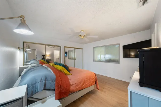 a bedroom with a bed and a flat screen tv