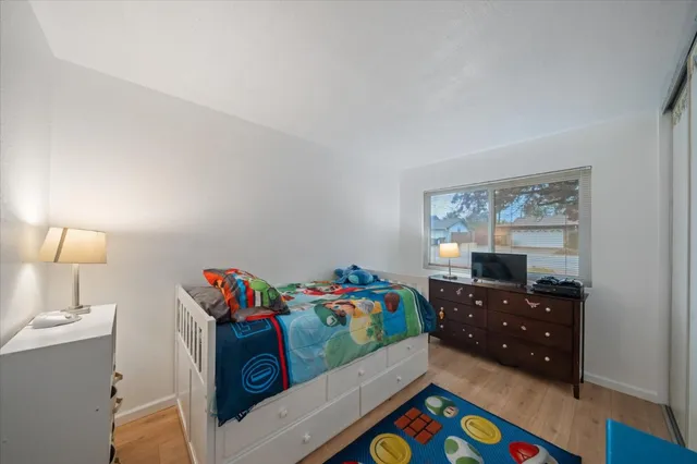 a bedroom with a bed and a window