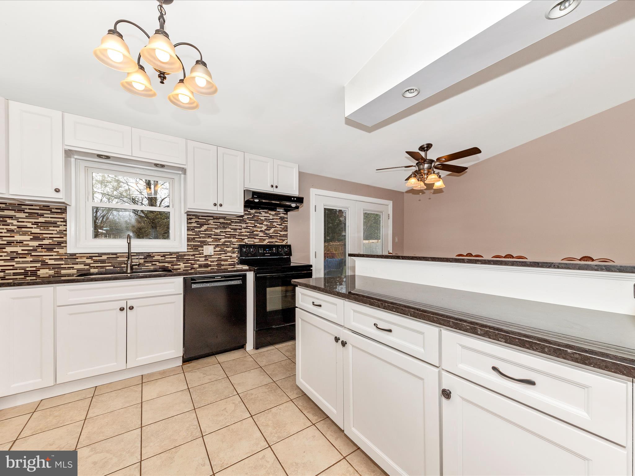 19005 Dowden Circle Poolesville, MD 20837 - Photo 11 of 51 a kitchen with a stove cabinets and window