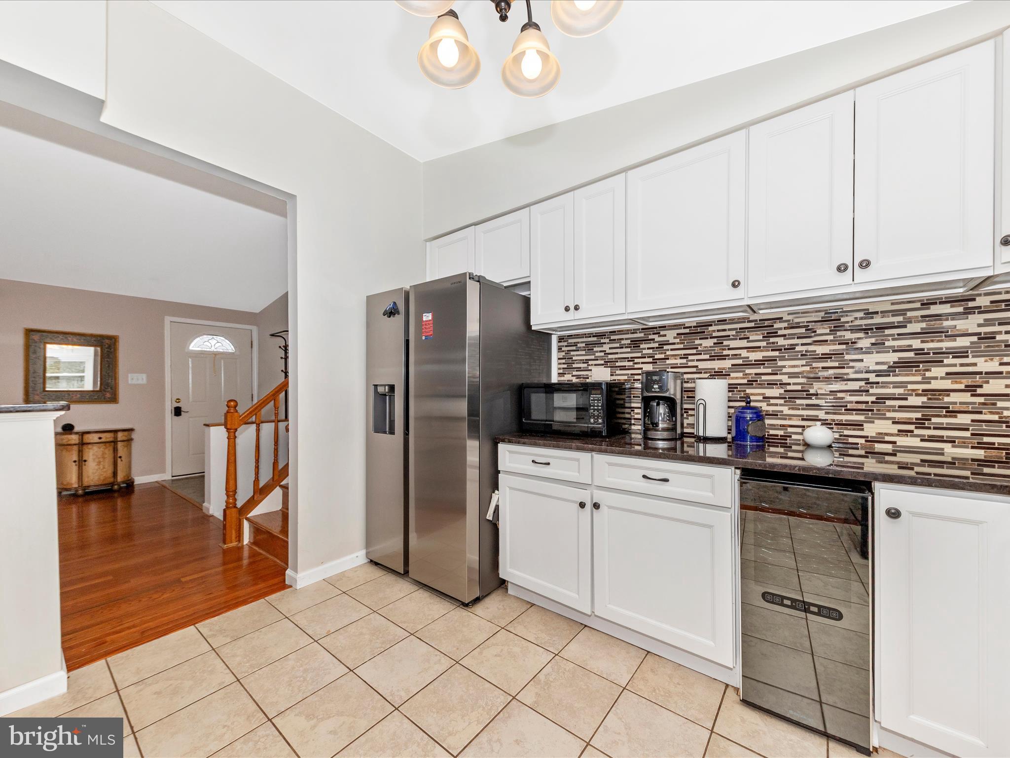 19005 Dowden Circle Poolesville, MD 20837 - Photo 12 of 51 a kitchen with white cabinets and stainless steel appliances