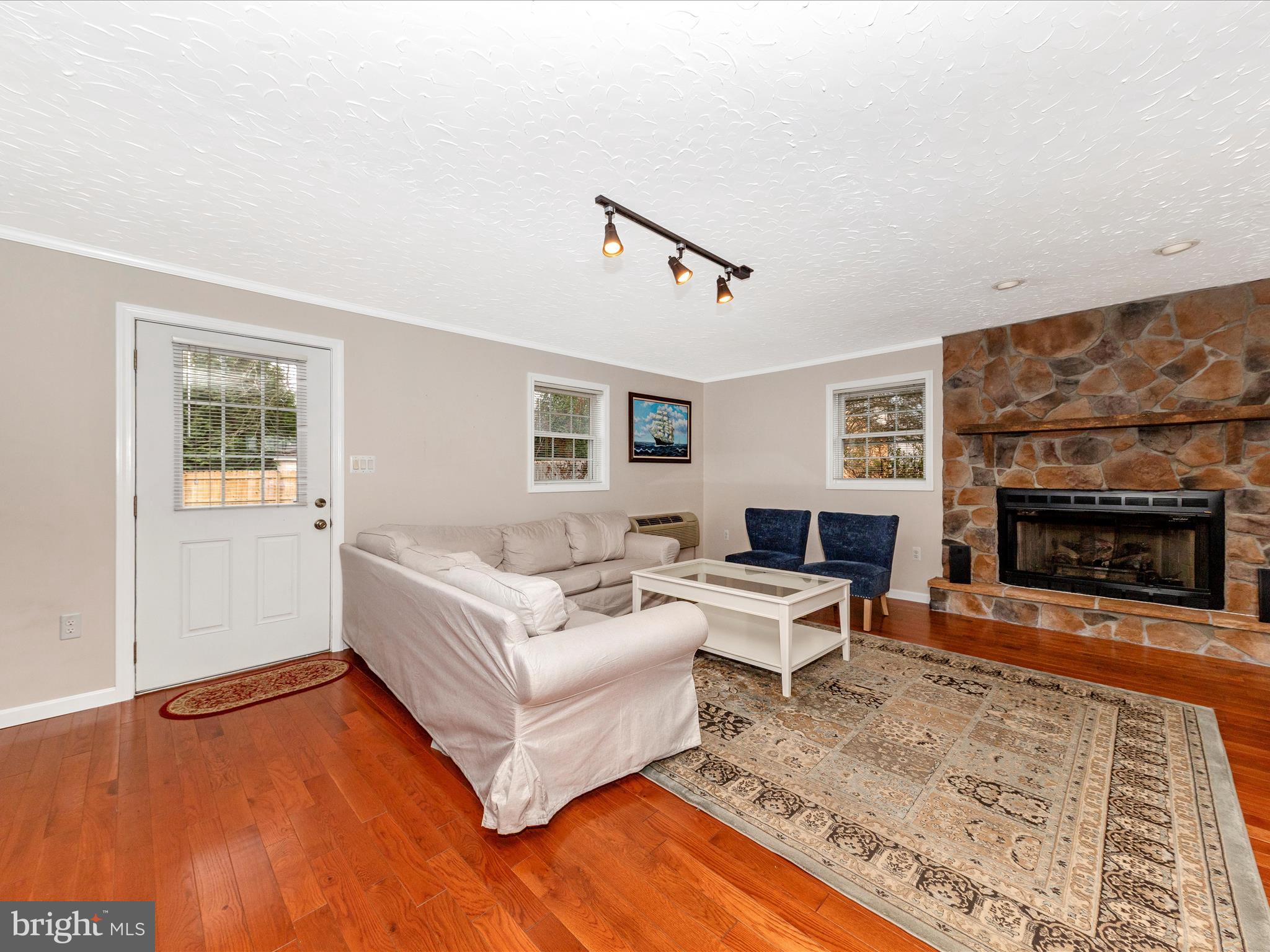19005 Dowden Circle Poolesville, MD 20837 - Photo 17 of 51 a living room with furniture and a fireplace