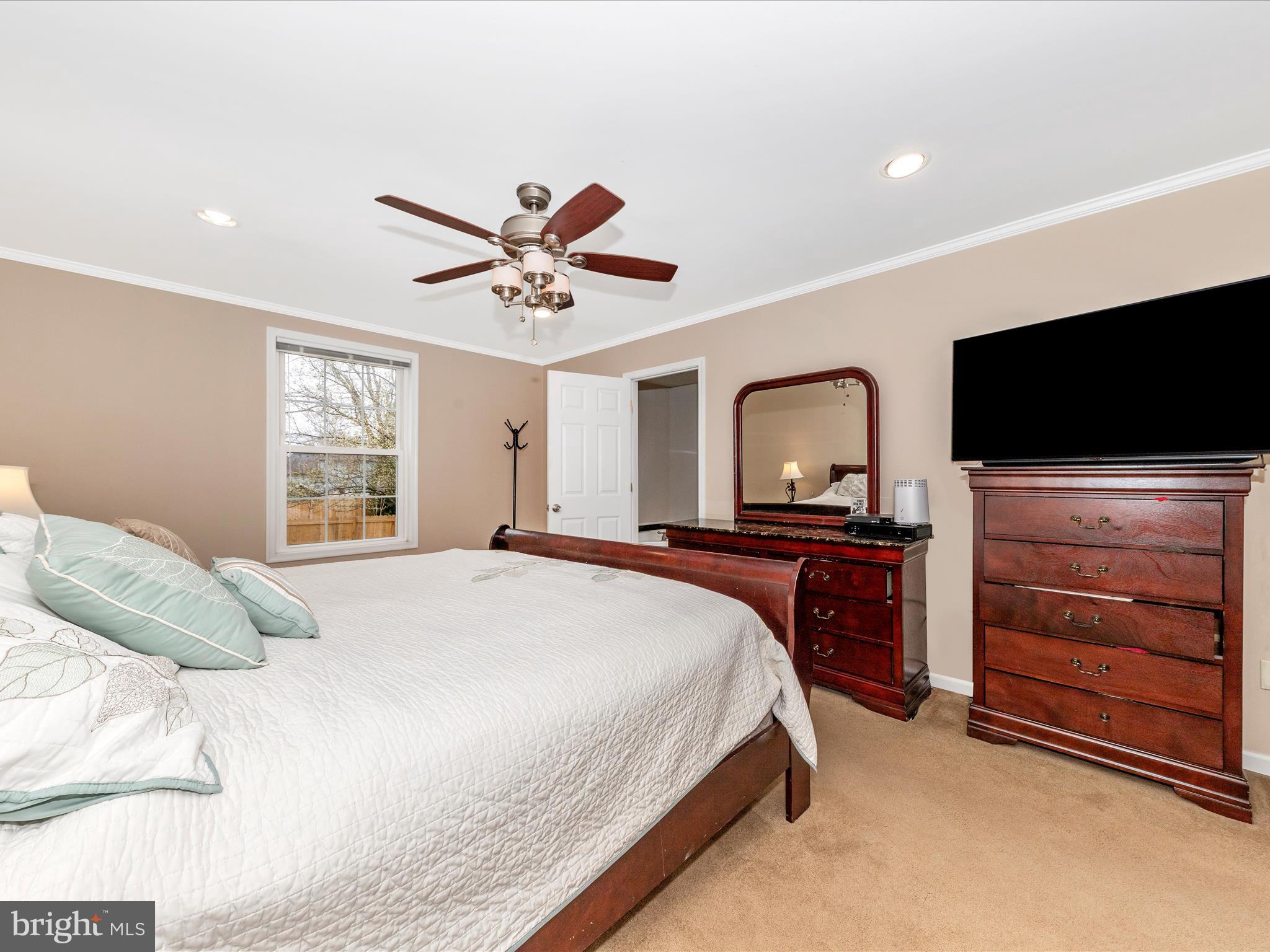 19005 Dowden Circle Poolesville, MD 20837 - Photo 20 of 51 a bedroom with a bed and a flat screen tv