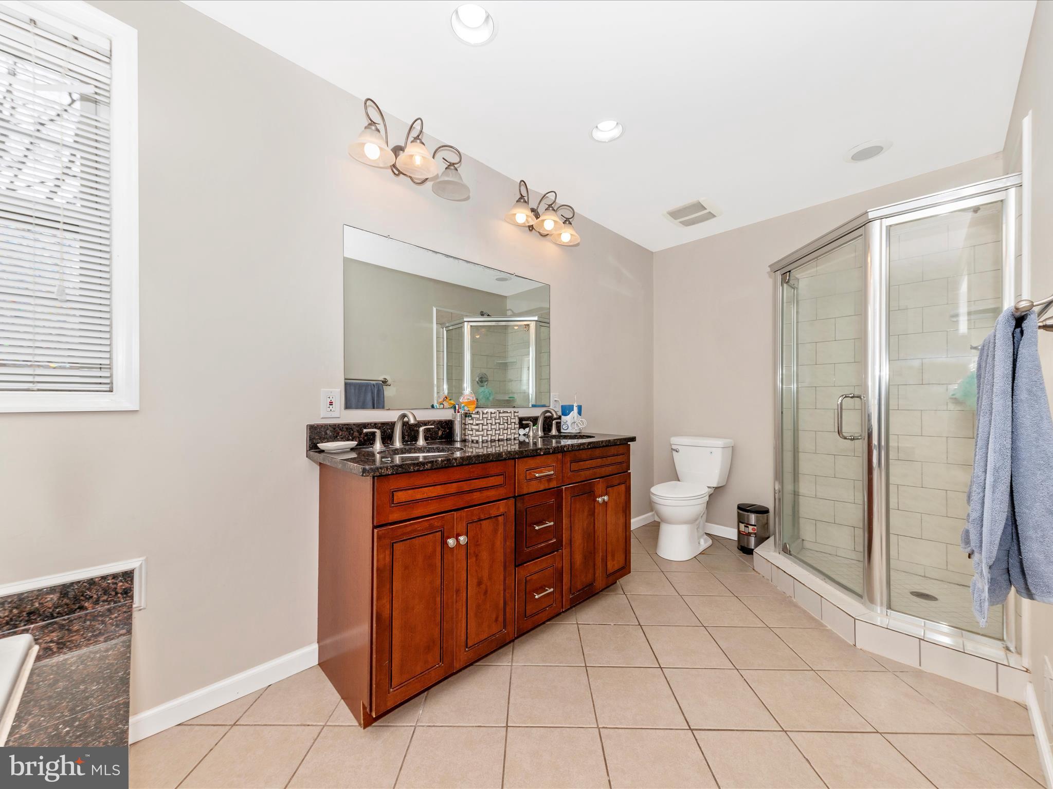 19005 Dowden Circle Poolesville, MD 20837 - Photo 22 of 51 a spacious bathroom with a sink mirror and a shower