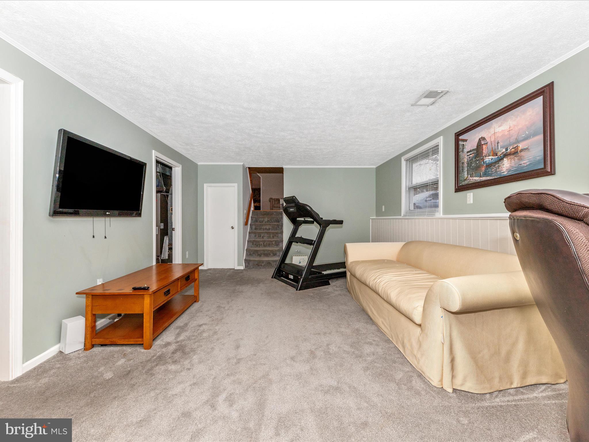 19005 Dowden Circle Poolesville, MD 20837 - Photo 32 of 51 a living room with furniture and a flat screen tv