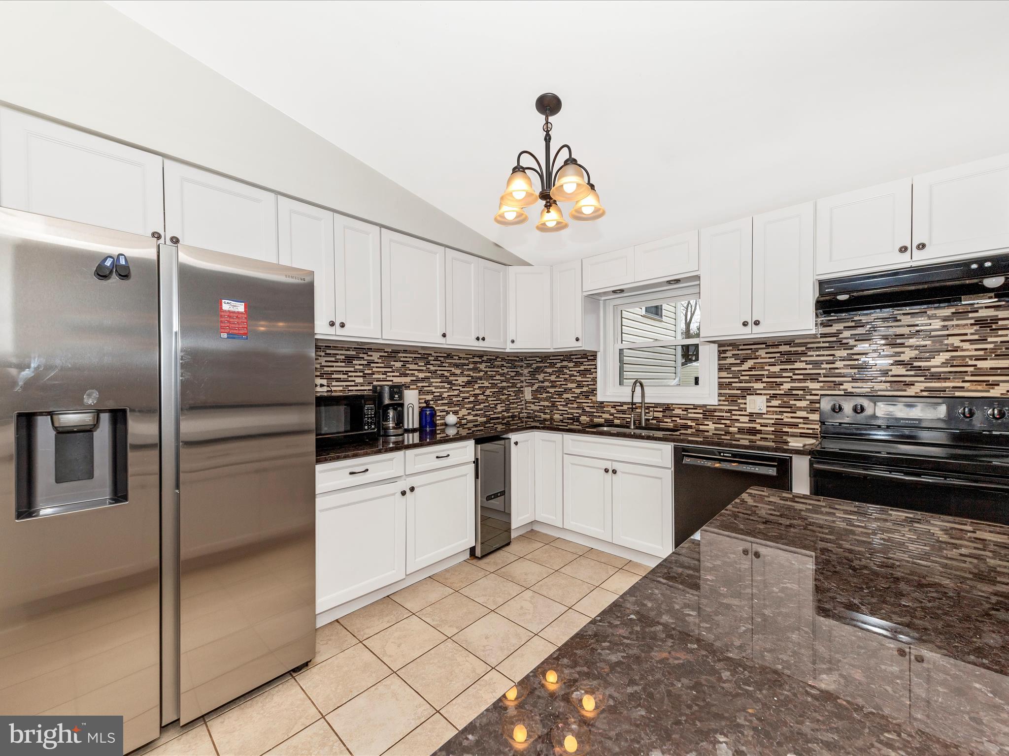 19005 Dowden Circle Poolesville, MD 20837 - Photo 9 of 51 a kitchen with granite countertop stainless steel appliances and a refrigerator