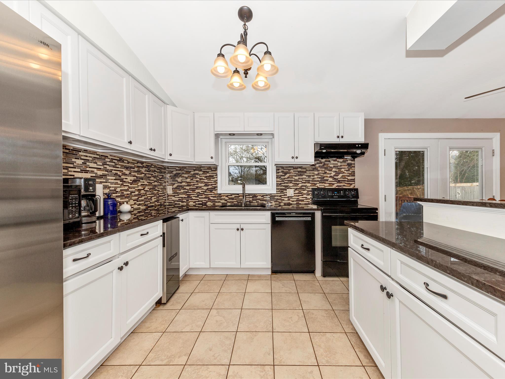 19005 Dowden Circle Poolesville, MD 20837 - Photo 10 of 51 a kitchen with stainless steel appliances cabinets a sink and a stove
