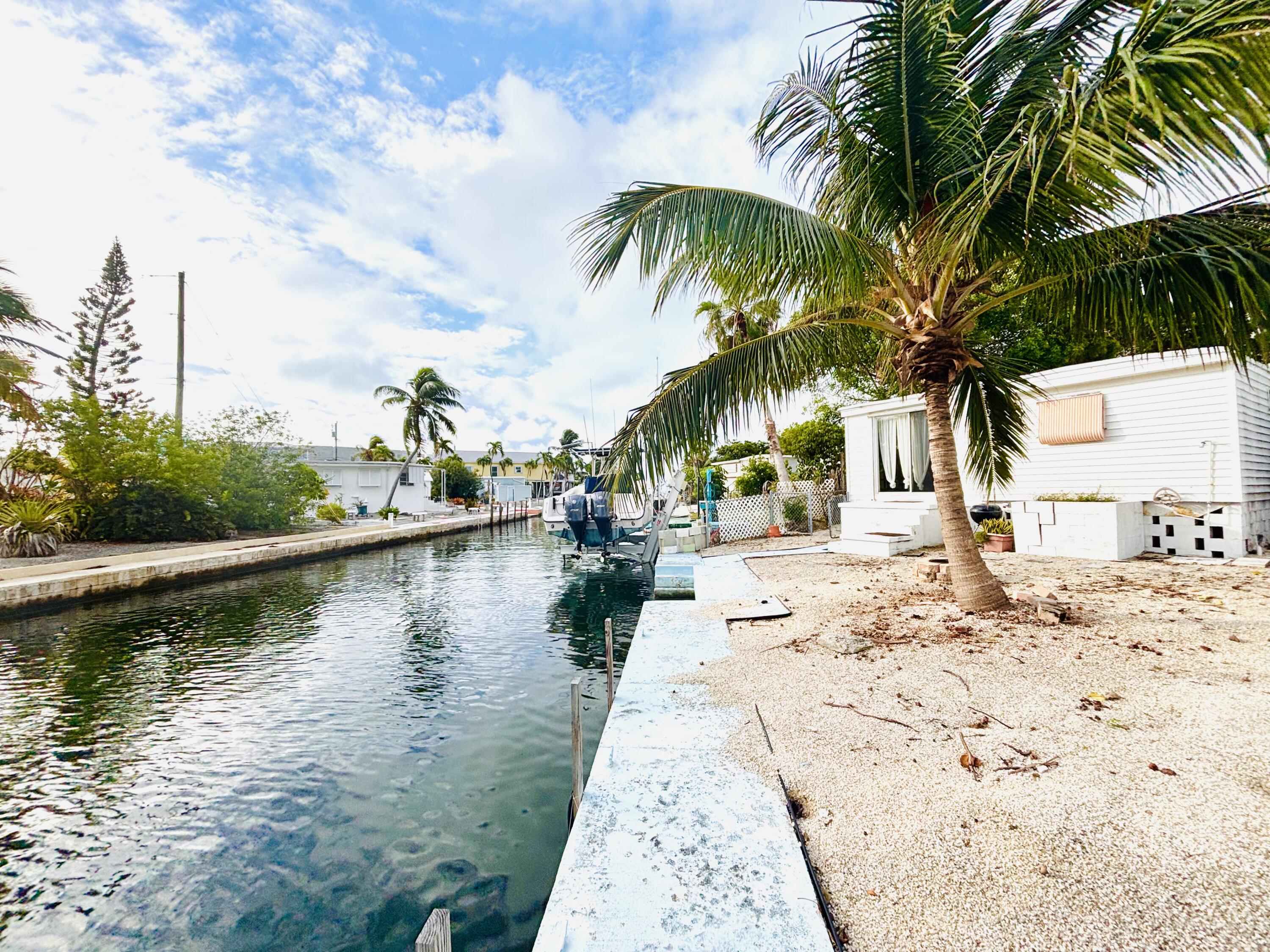 47 Boundary Lane Key West, FL 33040 - Photo 2 of 16 a view of a lake with palm trees