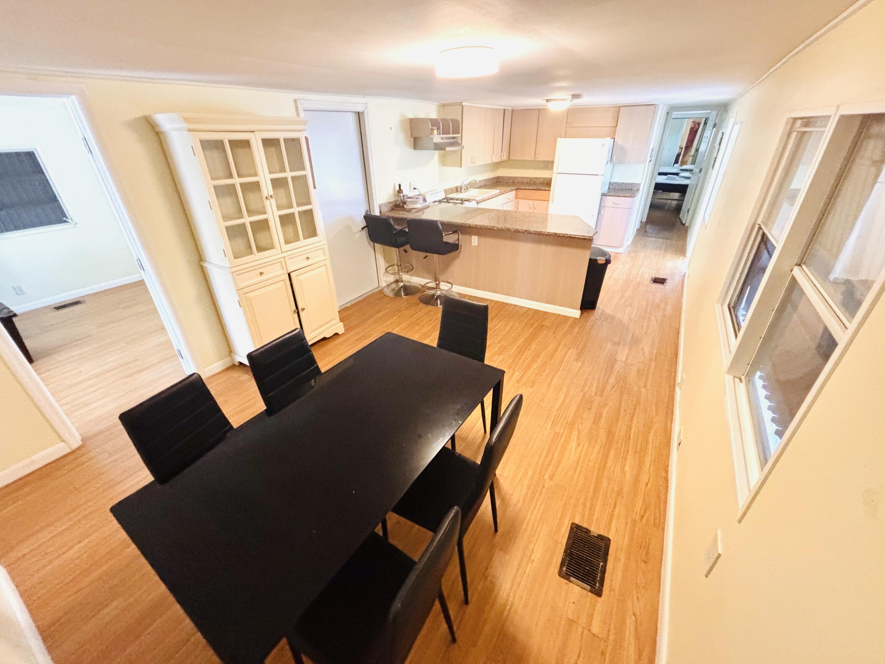 47 Boundary Lane Key West, FL 33040 - Photo 4 of 16 a living room with a couch and a dining table with wooden floor