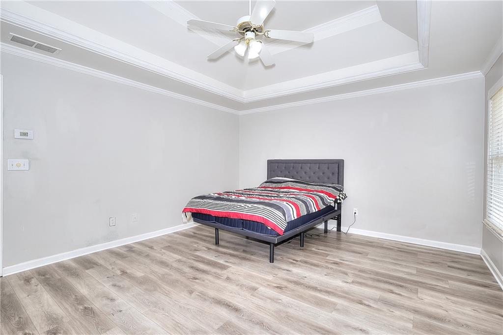 2520 Potomac View Court Grayson, GA 30017 - Photo 16 of 32 a bedroom with a bed and a ceiling fan