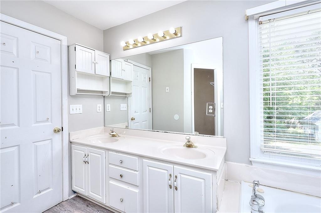 2520 Potomac View Court Grayson, GA 30017 - Photo 18 of 32 a bathroom with a double vanity sink and a mirror