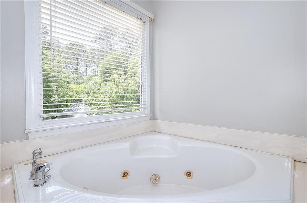 2520 Potomac View Court Grayson, GA 30017 - Photo 20 of 32 a white bath tub sitting in a bathroom next to a window