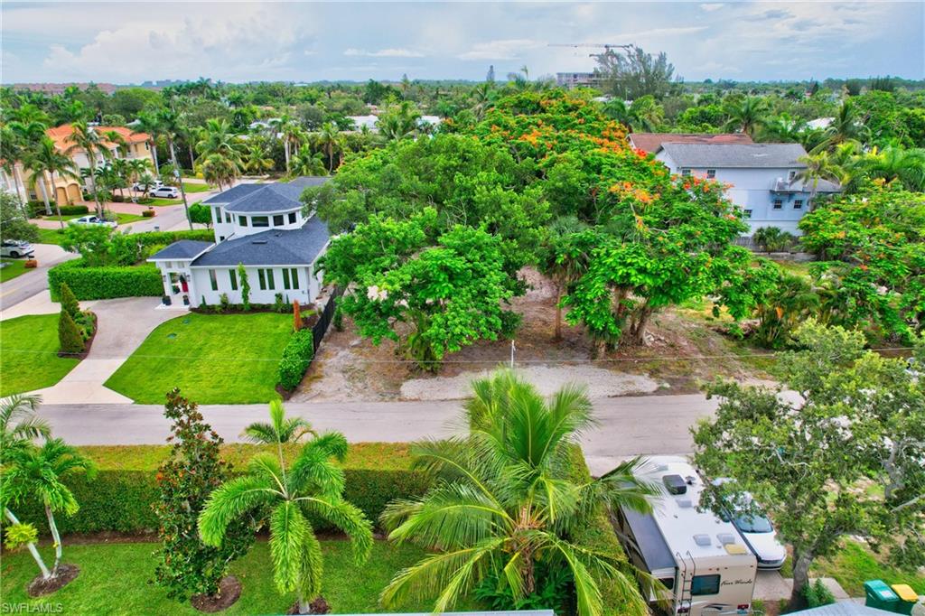 an aerial view of a house with garden space and street view