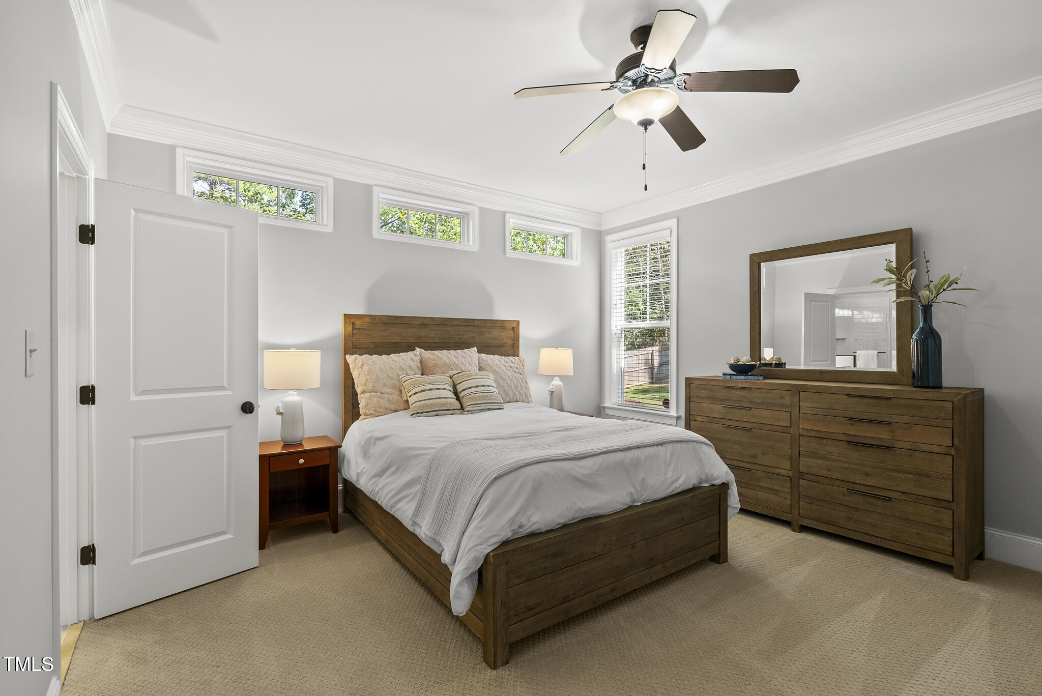 2216 Gresham Lake Road Raleigh, NC 27615 - Photo 9 of 52 a bedroom with a bed and a chandelier