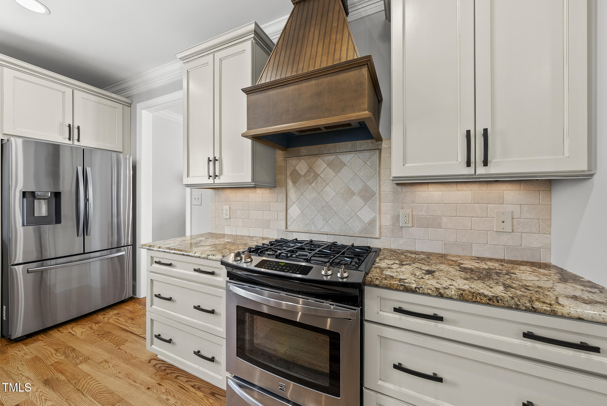 2216 Gresham Lake Road Raleigh, NC 27615 - Photo 20 of 52 a kitchen with granite countertop cabinets stainless steel appliances and wooden floor