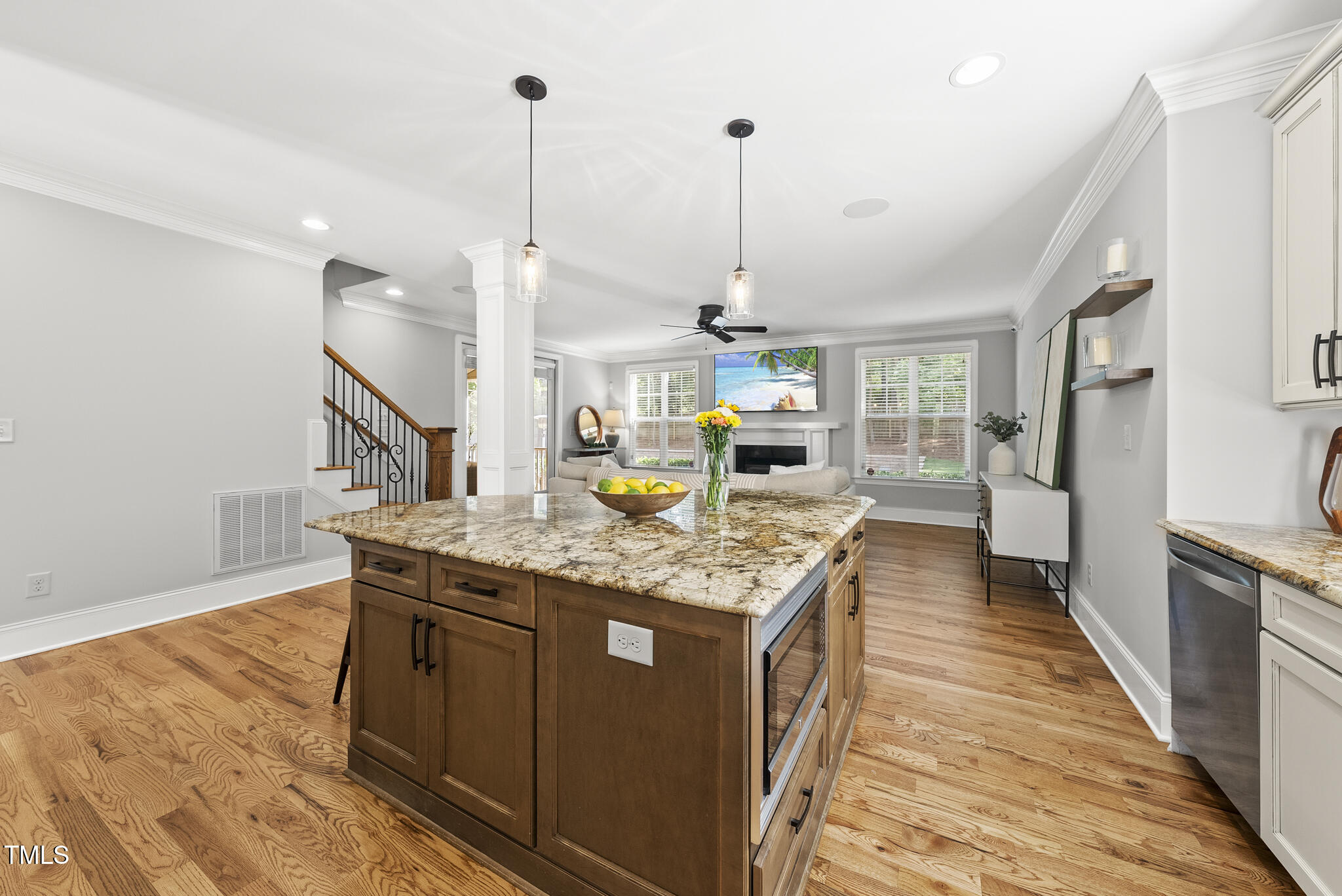 2216 Gresham Lake Road Raleigh, NC 27615 - Photo 23 of 52 a kitchen with stainless steel appliances granite countertop counter space and wooden floor