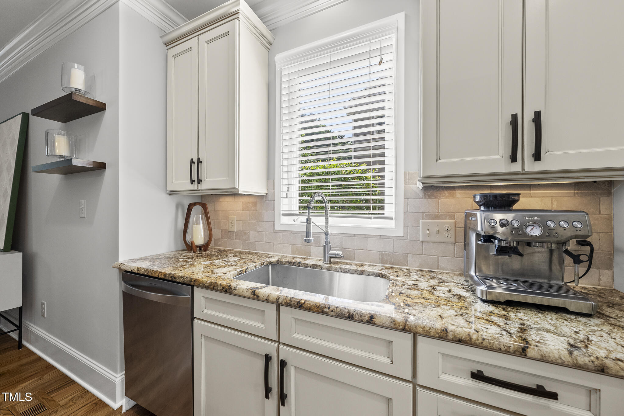 2216 Gresham Lake Road Raleigh, NC 27615 - Photo 24 of 52 a kitchen with kitchen island granite countertop white cabinets and white appliances