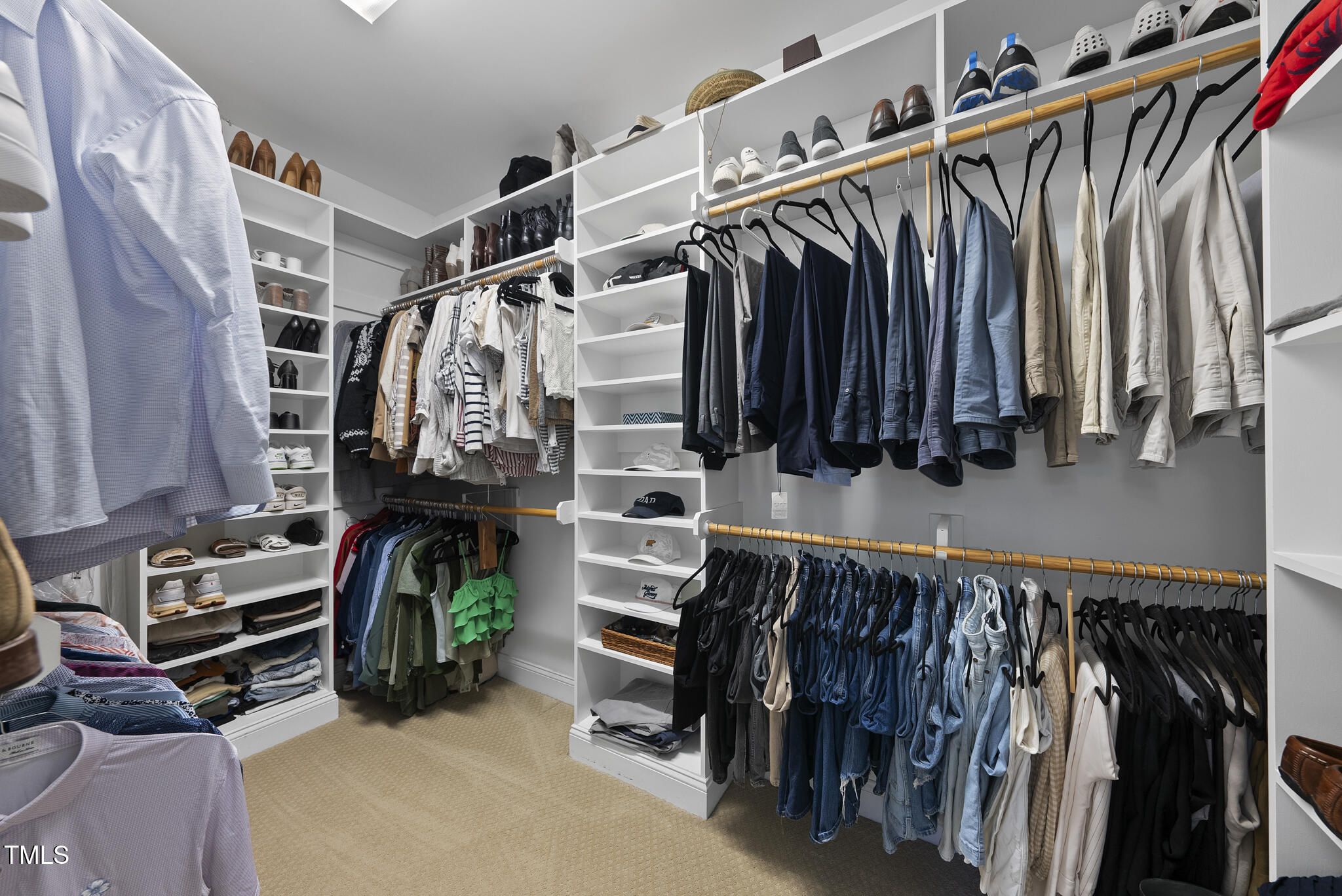 2216 Gresham Lake Road Raleigh, NC 27615 - Photo 31 of 52 a view of walk in closet with clothes and shoes