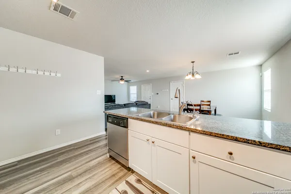 a kitchen with sink and cabinets