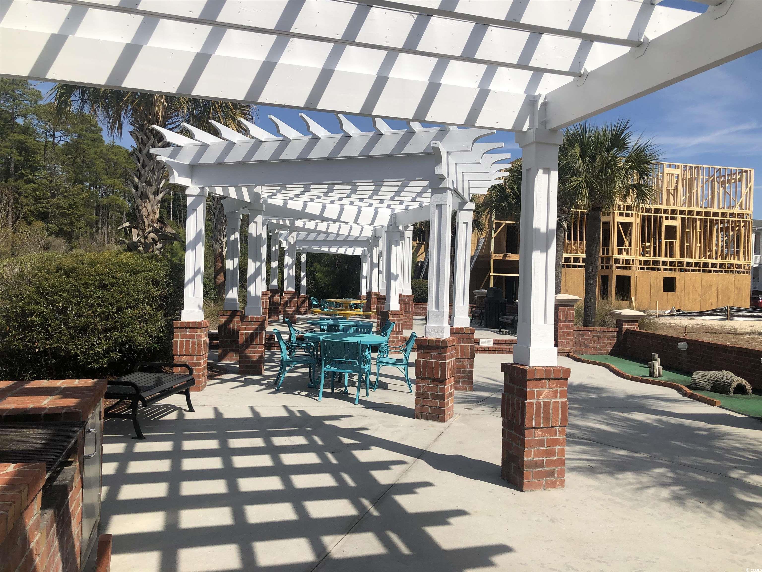 1025 Ray Costin Way, Unit 1008 Murrells Inlet, SC 29576 - Photo 34 of 36 View of patio featuring outdoor dining area and a