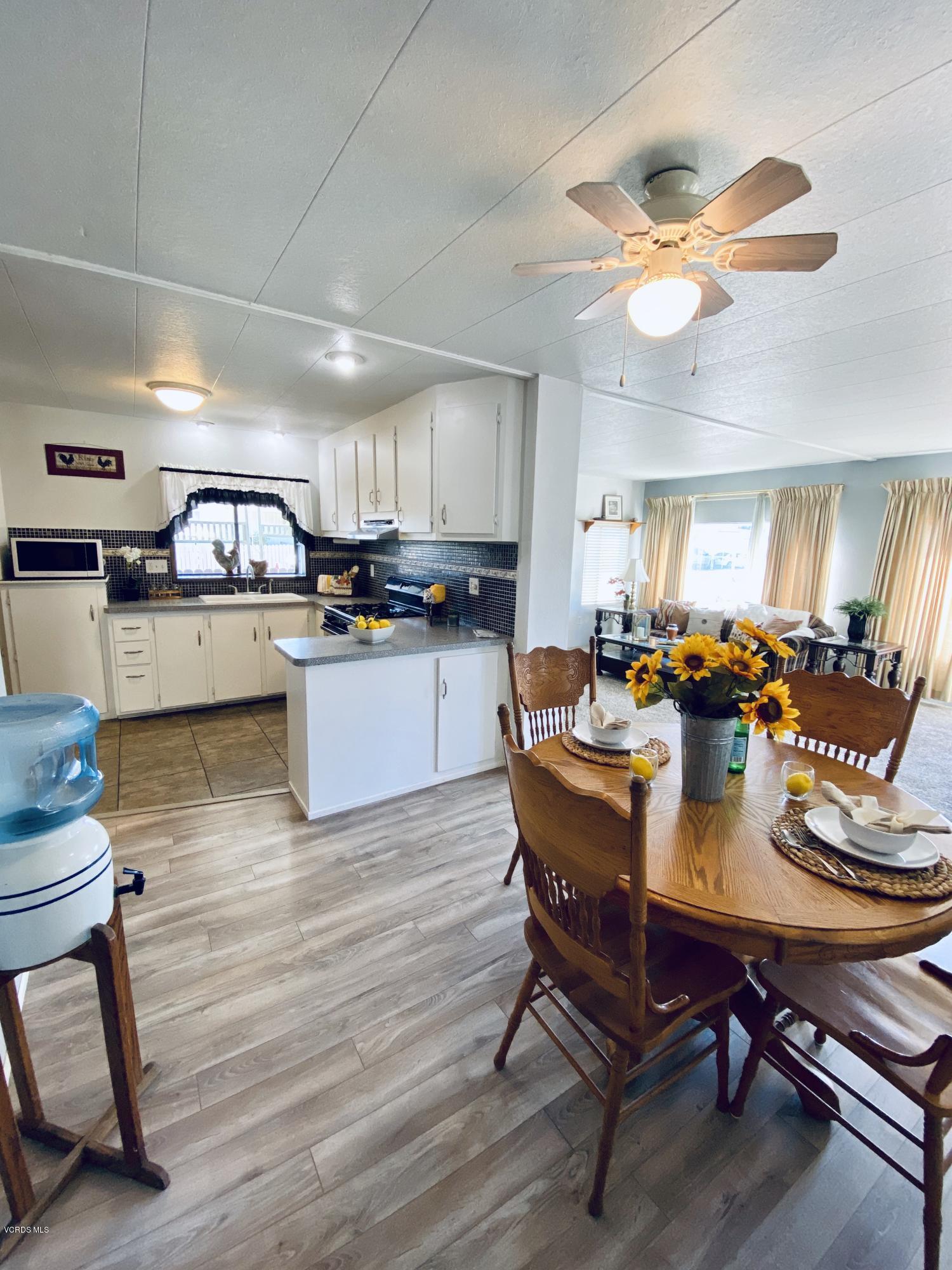 15433 West Telegraph Road, Unit 4 Santa Paula, CA 93060 - Photo 20 of 52 a kitchen with a dining table chairs and stove