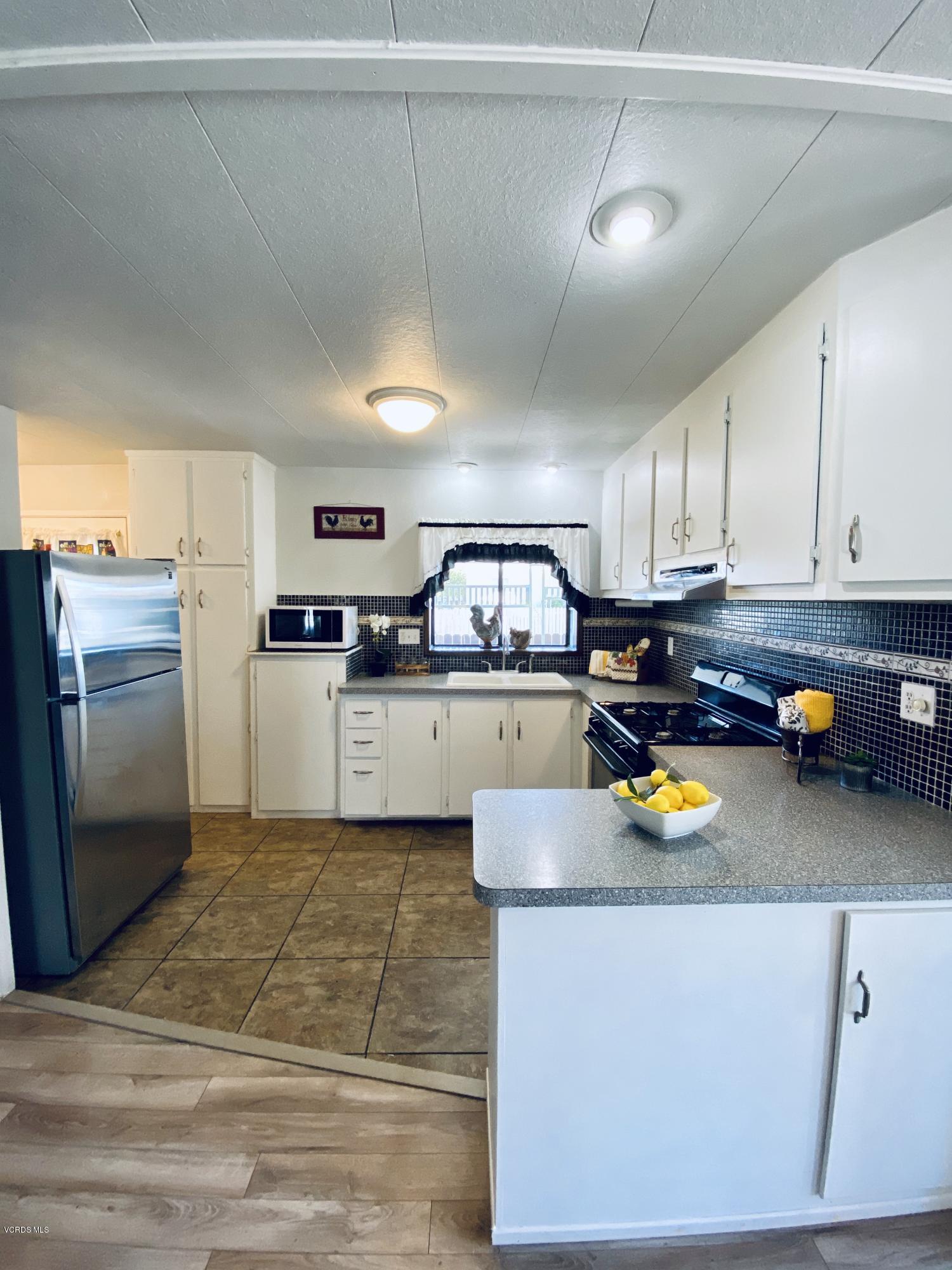 15433 West Telegraph Road, Unit 4 Santa Paula, CA 93060 - Photo 21 of 52 a kitchen with a refrigerator and a stove top oven