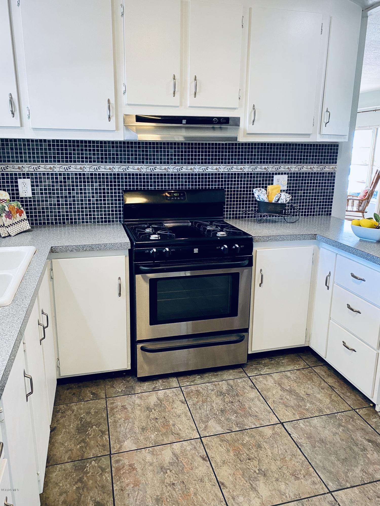 15433 West Telegraph Road, Unit 4 Santa Paula, CA 93060 - Photo 26 of 52 a kitchen with granite countertop white cabinets and appliances