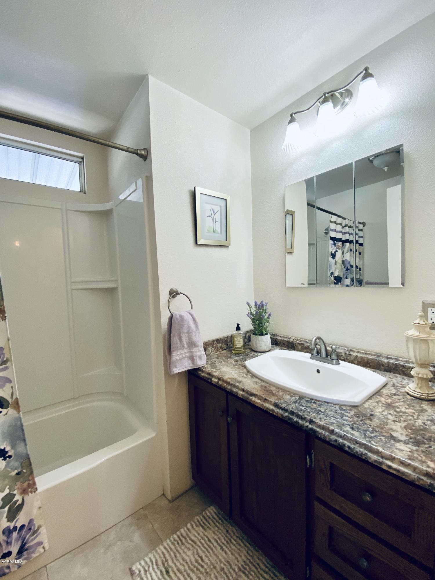 15433 West Telegraph Road, Unit 4 Santa Paula, CA 93060 - Photo 33 of 52 a bathroom with a tub a sink and mirror