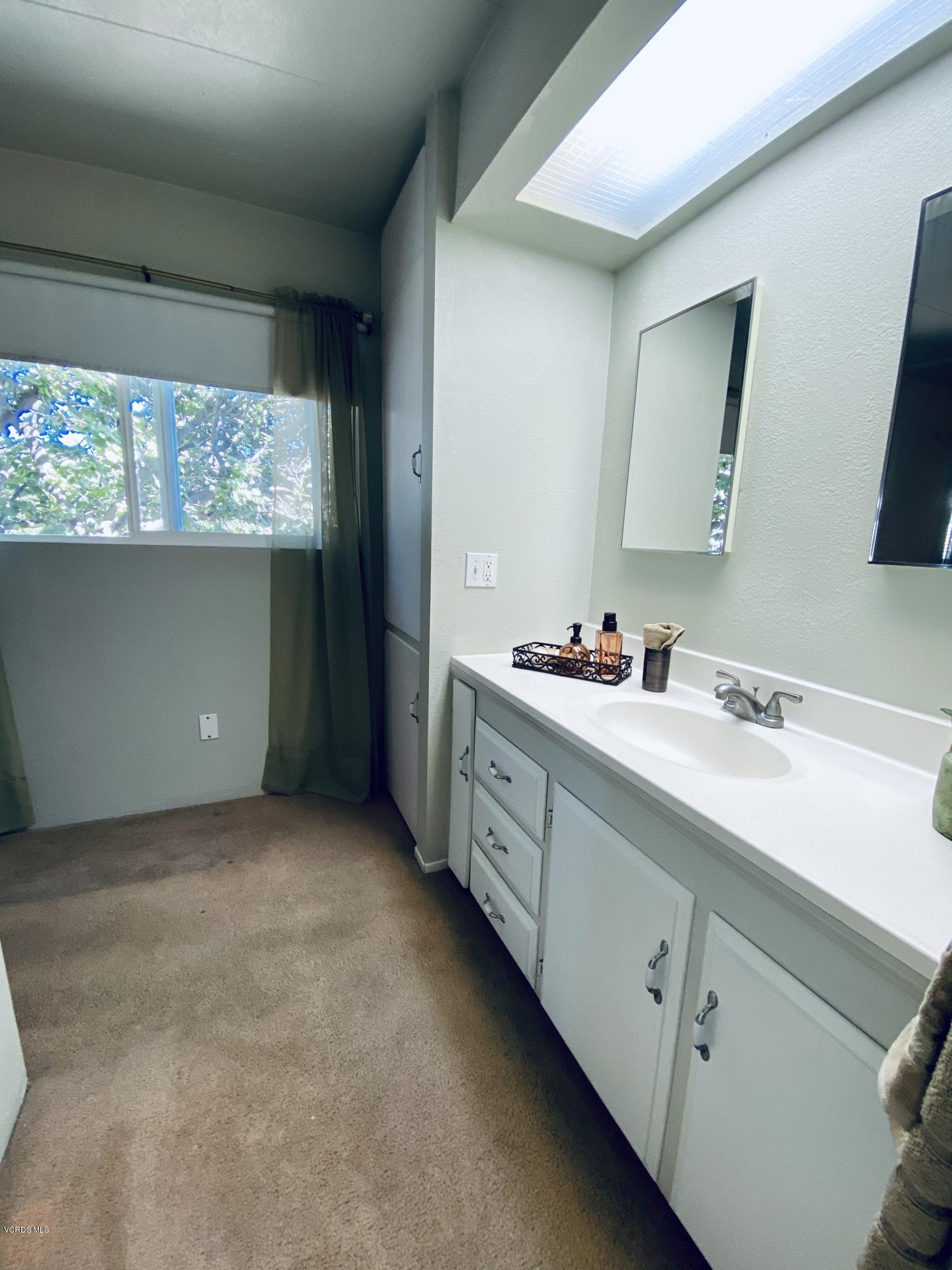 15433 West Telegraph Road, Unit 4 Santa Paula, CA 93060 - Photo 39 of 52 a bathroom with a double vanity sink and mirror