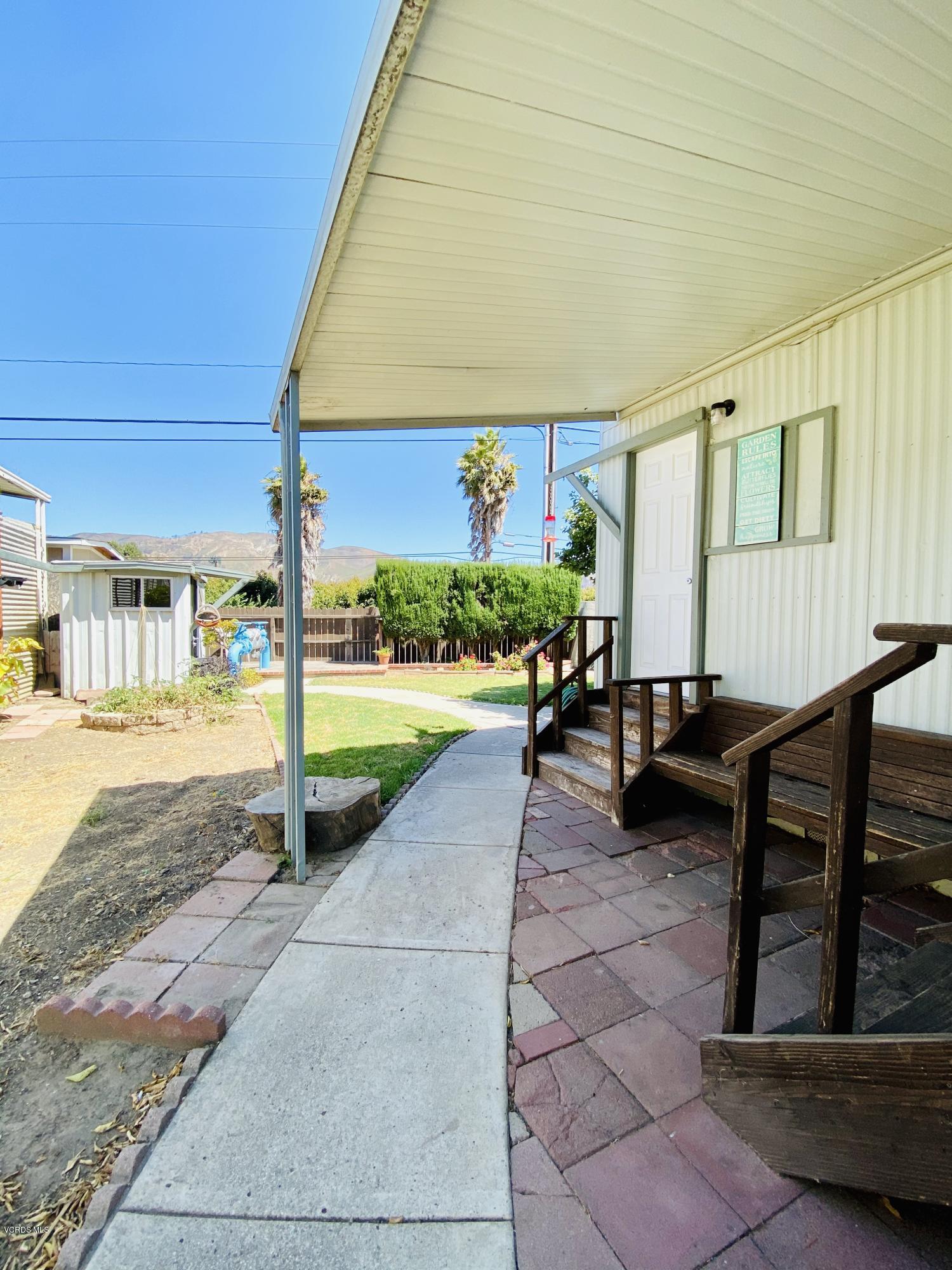 15433 West Telegraph Road, Unit 4 Santa Paula, CA 93060 - Photo 44 of 52 a view of a patio with table and chairs with wooden floor and fence