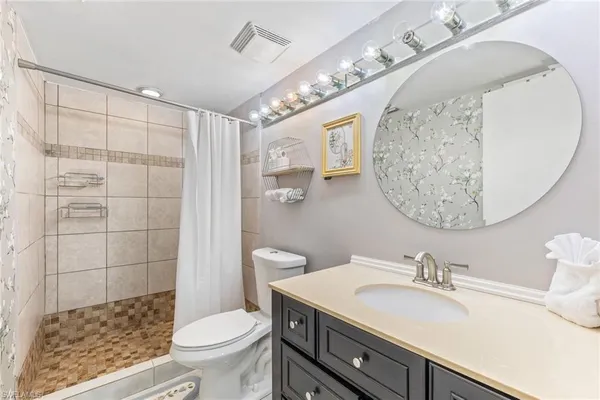 a bathroom with a sink toilet and shower