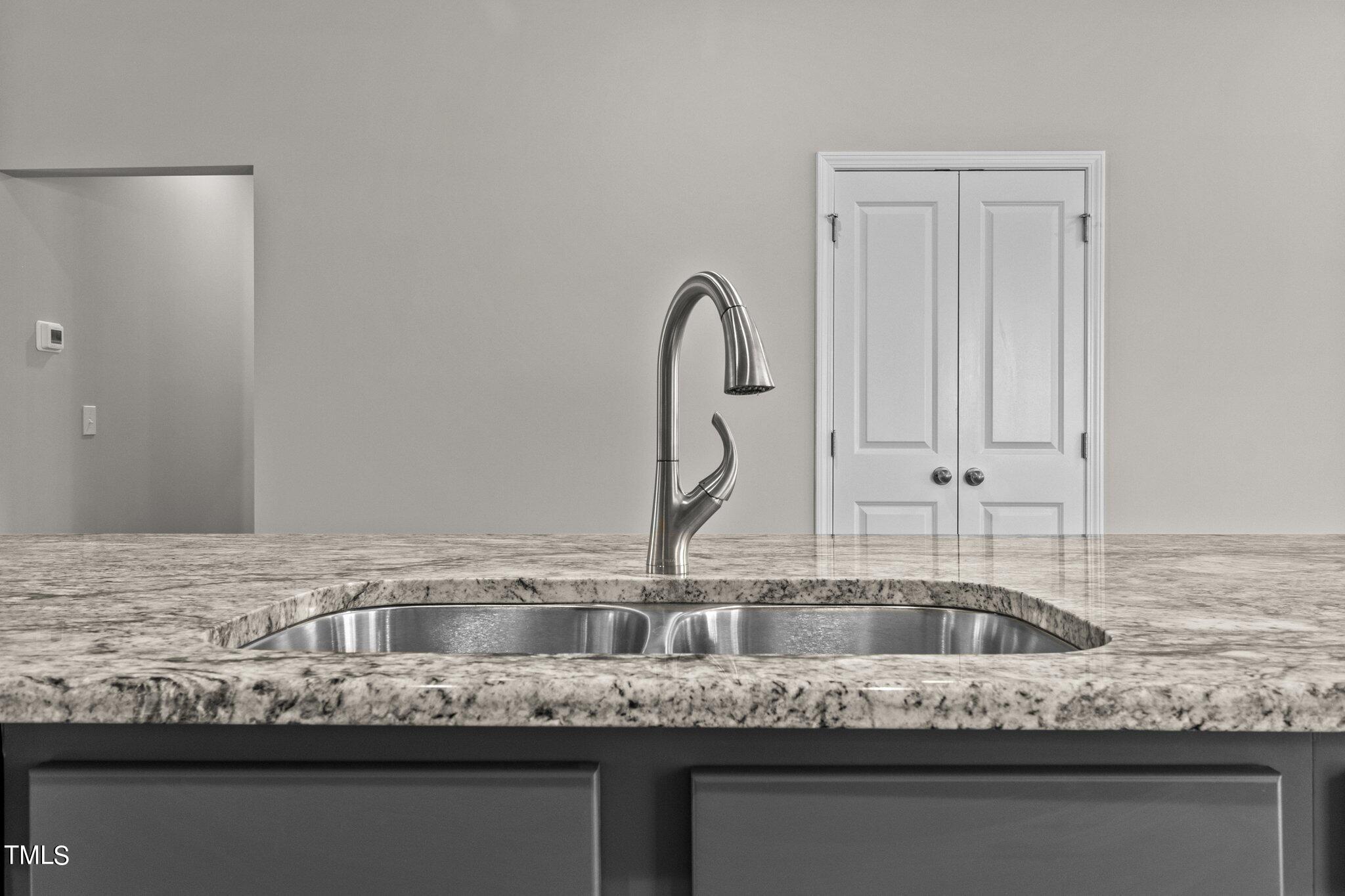 111 Regis Lane Coats, NC 27521 - Photo 11 of 36 a kitchen with granite countertop a sink and cabinets