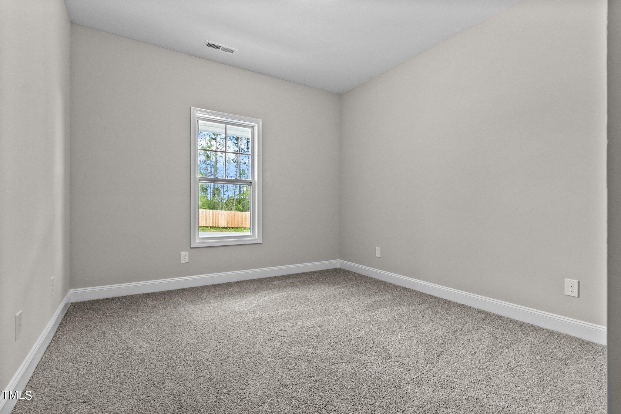 111 Regis Lane Coats, NC 27521 - Photo 17 of 36 an empty room with a window