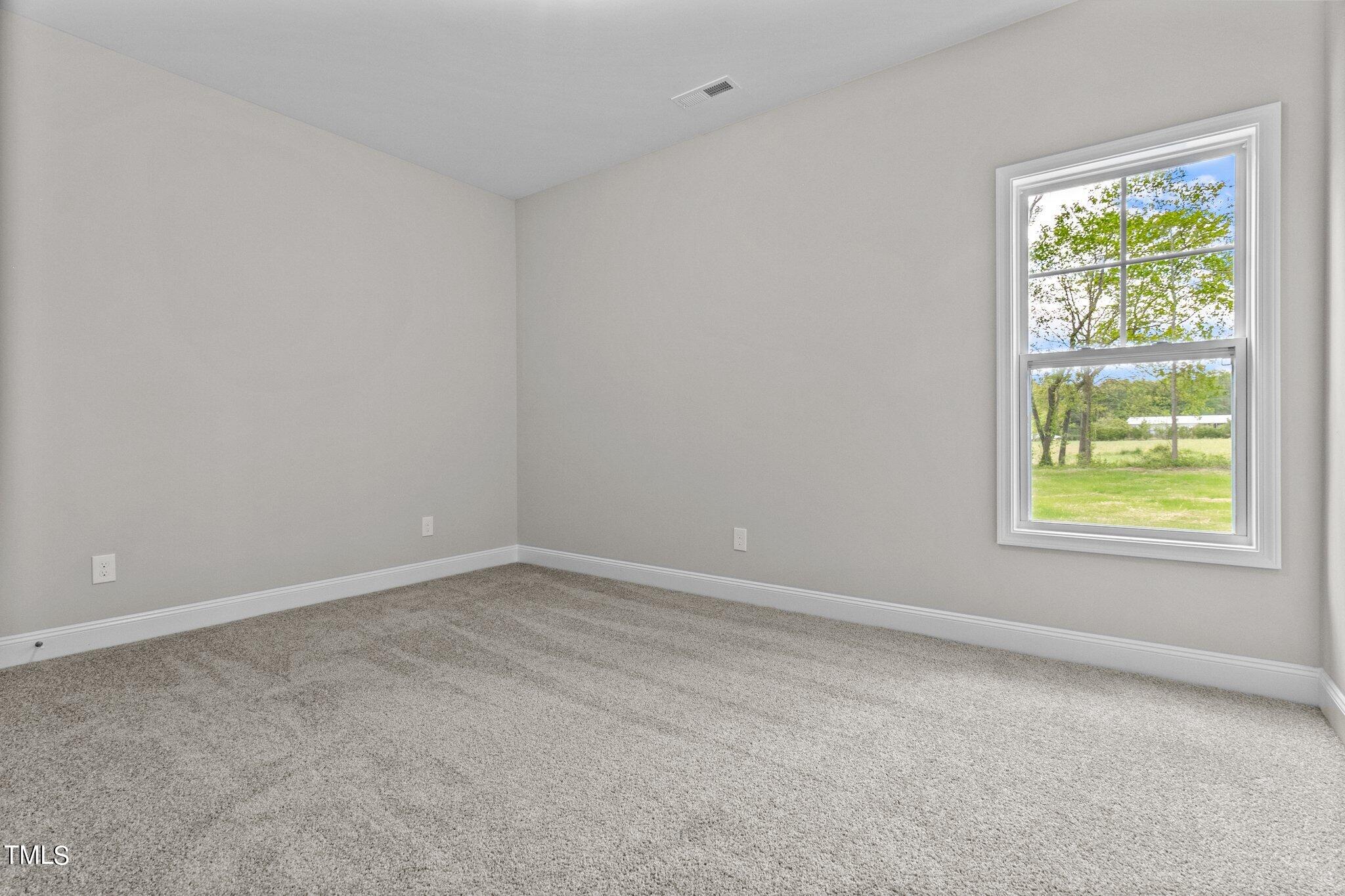 111 Regis Lane Coats, NC 27521 - Photo 19 of 36 an empty room with a window