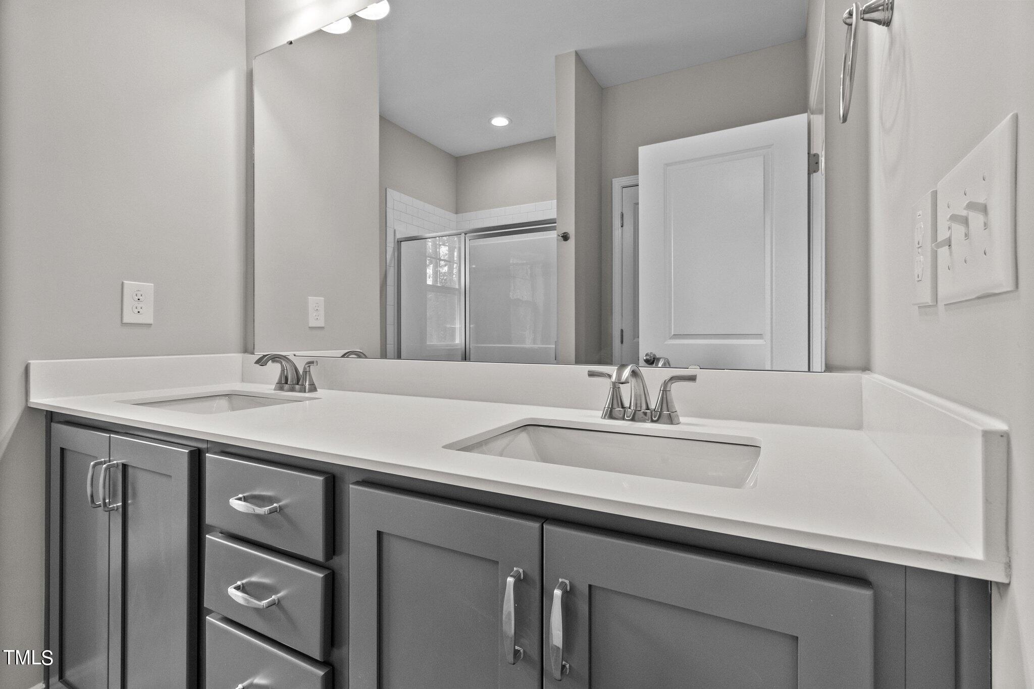 111 Regis Lane Coats, NC 27521 - Photo 23 of 36 a bathroom with a sink and a mirror