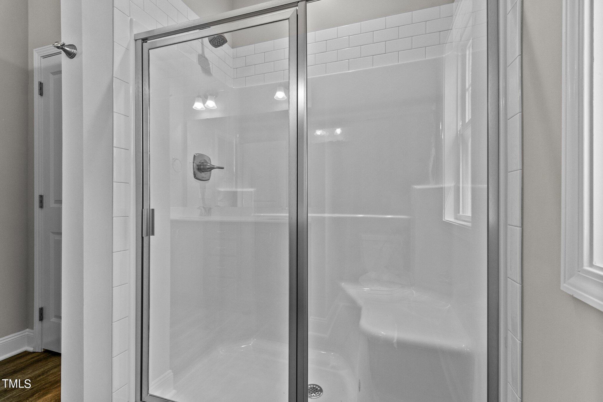 111 Regis Lane Coats, NC 27521 - Photo 24 of 36 a bathroom with a glass shower door