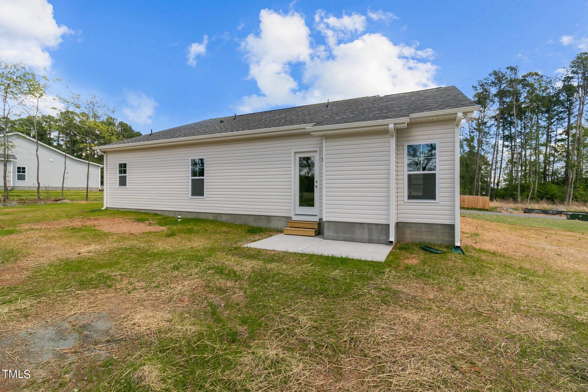 111 Regis Lane Coats, NC 27521 - Photo 26 of 36 a view of a house with a yard and a garage