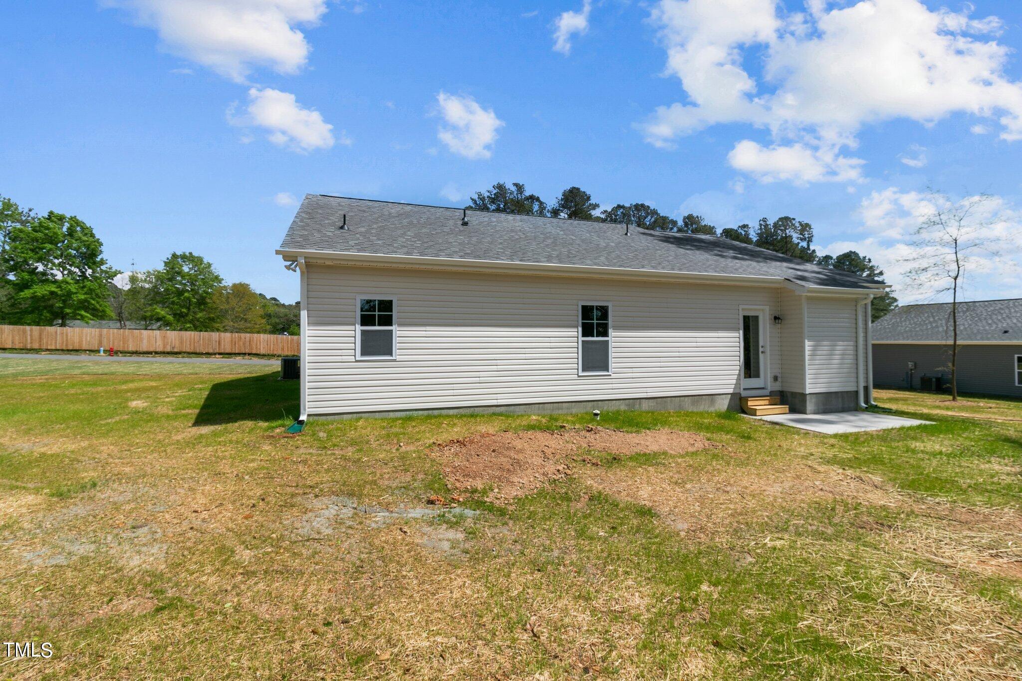 111 Regis Lane Coats, NC 27521 - Photo 29 of 36 a backyard of a house with table and chairs